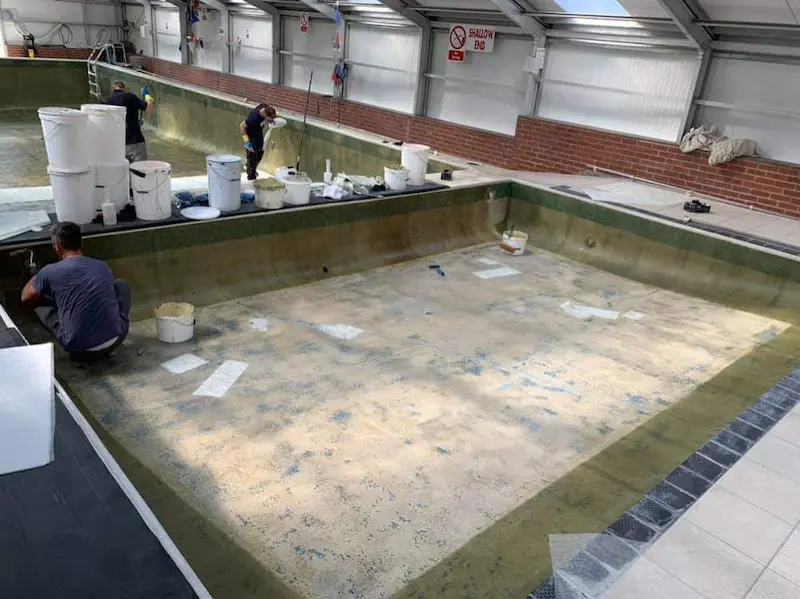 Applying fibreglass to the primed pool walls