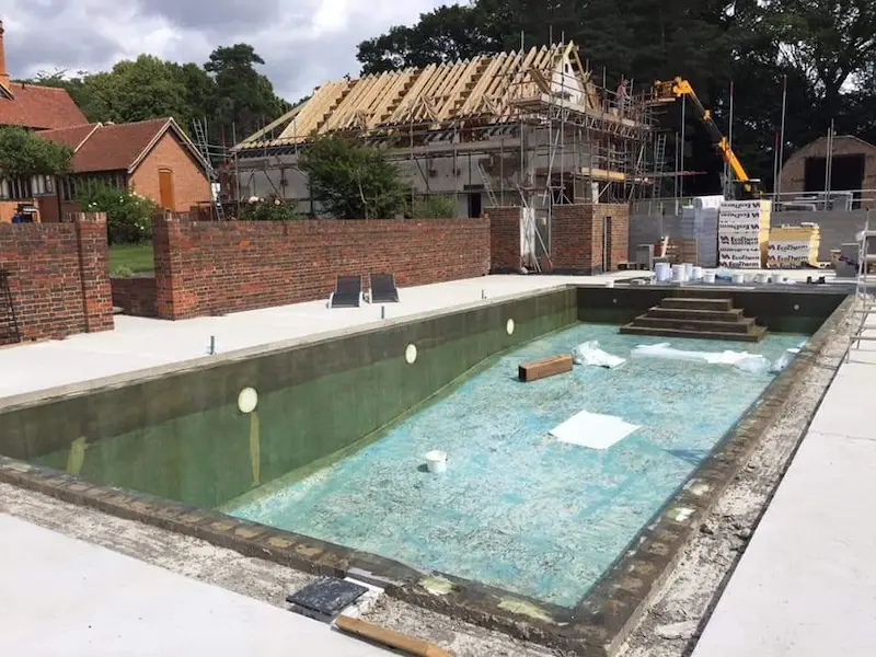 Applying the Fibreglass matting and surface veil to the pool walls