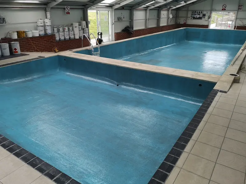 Pigmented vinyl ester resin coat applied to the laminate