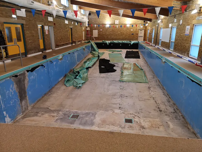 Removing the torn bag liner from the pool shell